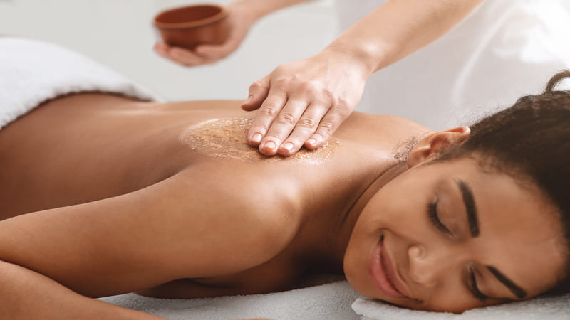 masseuse-applying-body-scrub-on-black-girl-back-2021-08-28-22-00-19-utc